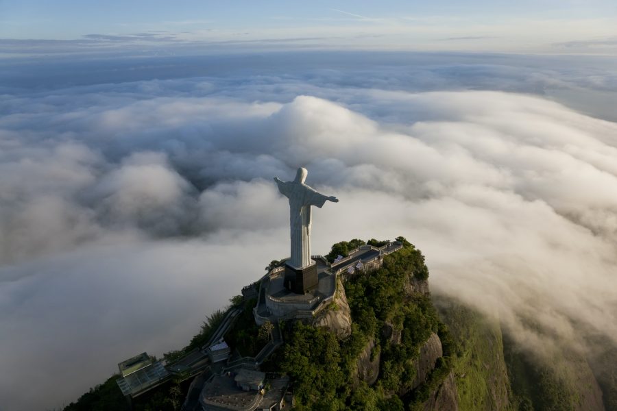 High angle view of colossal Christ Redeemer statue surrounded by clouds, Corcovado, Rio de Janeiro,